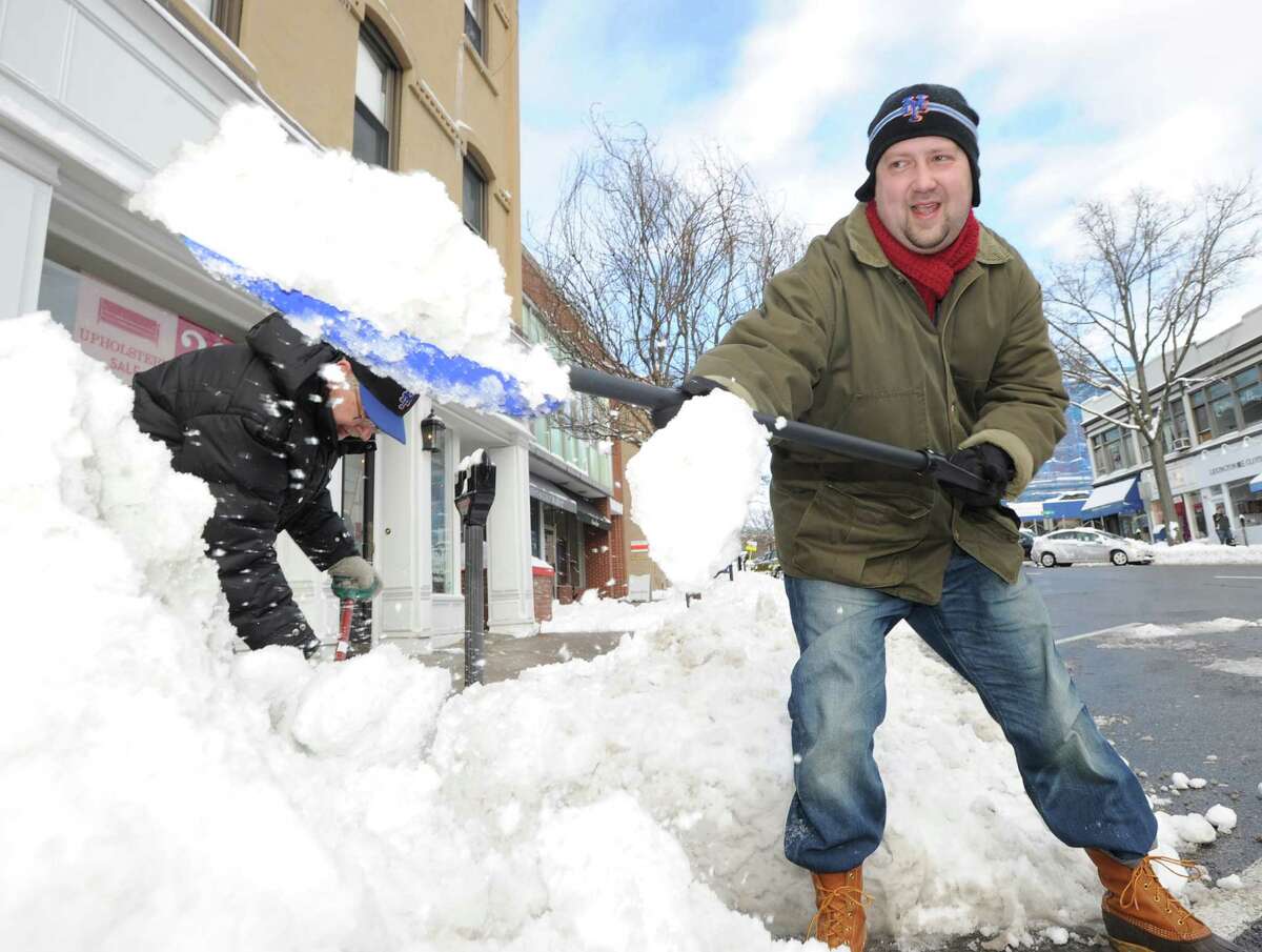 Nick Stroz, a Greenwich Avenue resident, clears snow from a sidewalk on the Avenue during the aftermath of the blizzard that hit Greenwich, Conn., Saturday morning, Feb. 9, 2013. Stroz said he was just trying to clear a path for others and to be helpful during the storm.