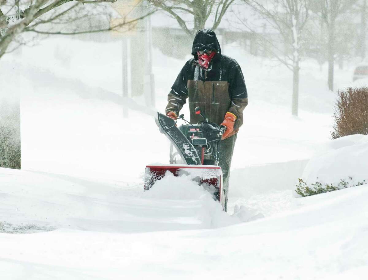 Cliff Ritter of Woodbury cuts through the drifts in front of Copps Hill Commons in Ridgefield, after the snowstorm moved out. Saturday, Feb. 9, 2013