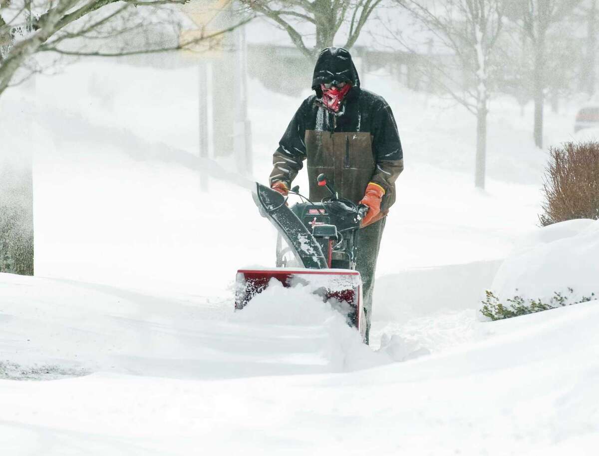 Cliff Ritter of Woodbury cuts through the drifts in front of Copps Hill Commons in Ridgefield, after the snowstorm moved out. Saturday, Feb. 9, 2013