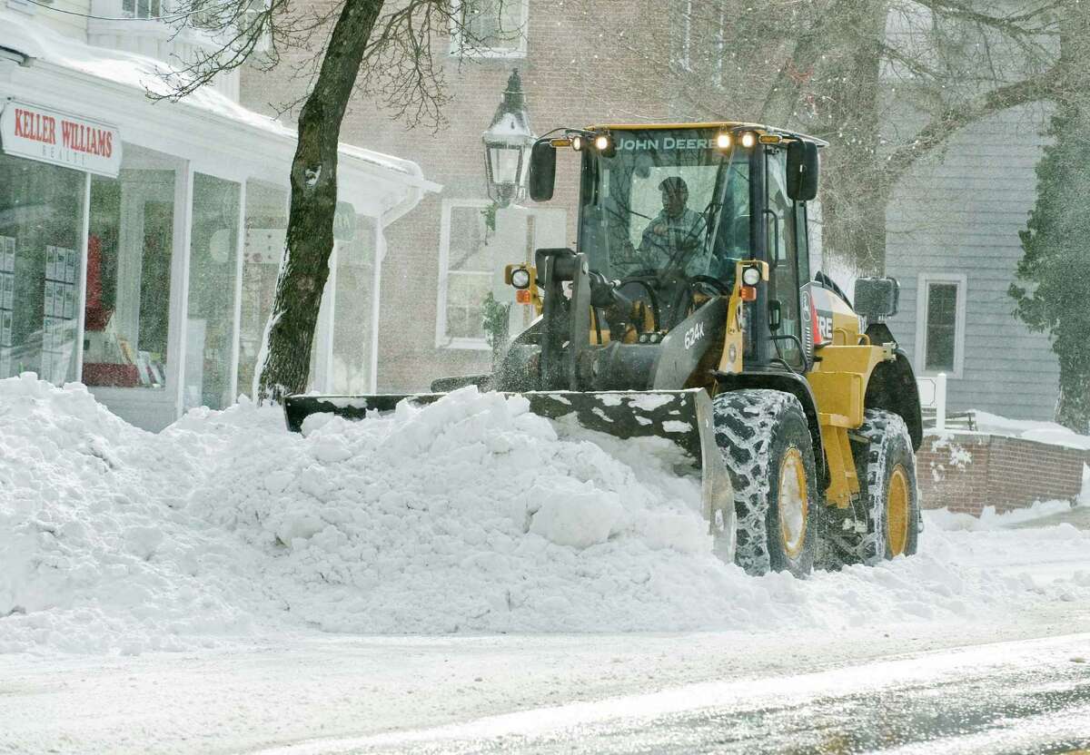 Heavy equipment clears Main Street near Town Hall in Ridgefield after the snowstorm. Saturday, Feb. 9, 2013