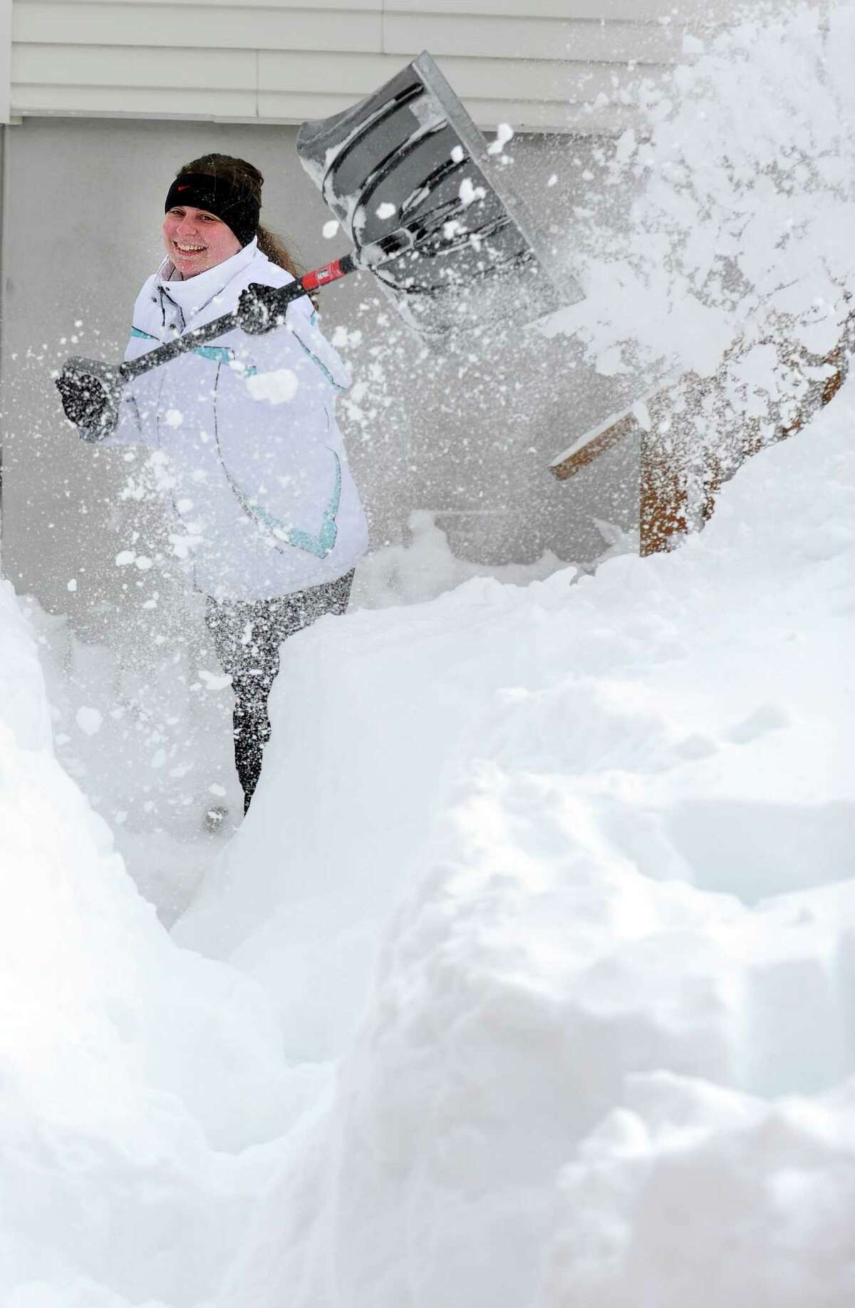 Tania Tchir shovels a path from her house in Derby, Conn. as residents face massive snow removal Saturday, Feb. 9, 2013 following a severe blizzard that dumped up to three feet of snow across the state.