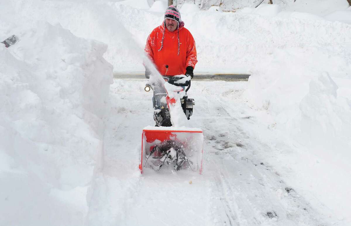 Dave Stec uses a snowblower to clear his driveway in Derby, Conn. as residents face massive snow removal Saturday, Feb. 9, 2013 following a severe blizzard that dumped up to three feet of snow across the state.
