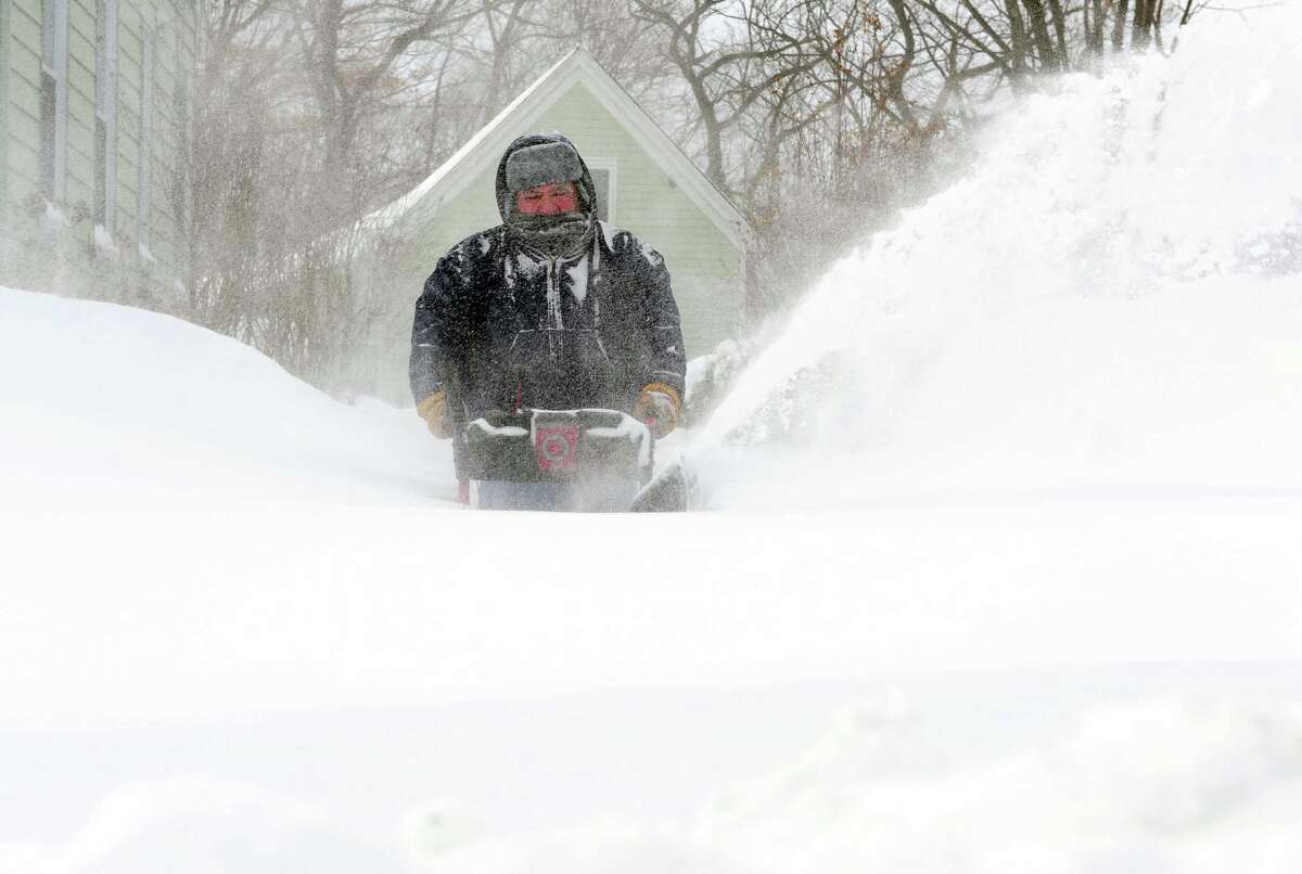 Moises Diaz uses a snowblower to clear his driveway in Derby, Conn. as residents face massive snow removal Saturday, Feb. 9, 2013 following a severe blizzard that dumped up to three feet of snow across the state.