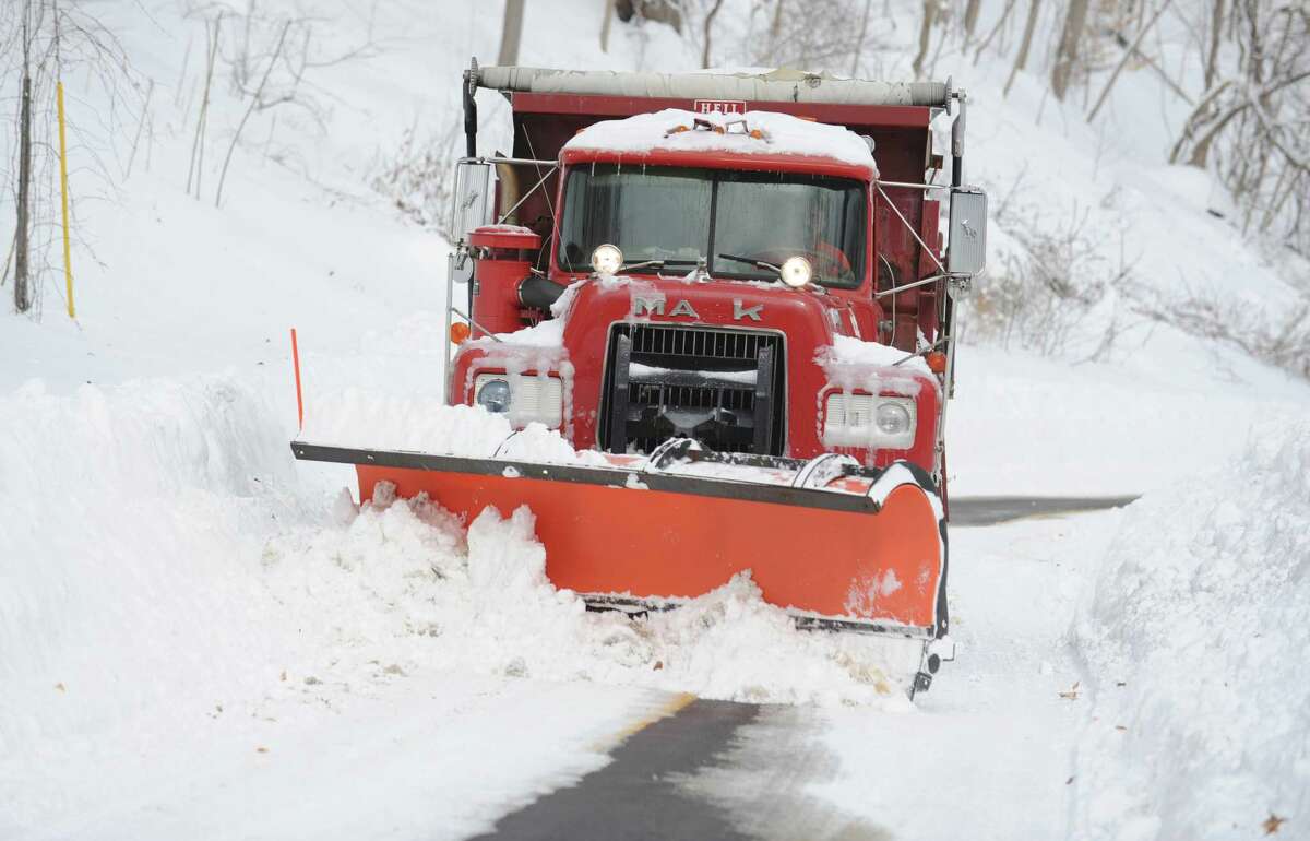 A plow truck pushes snow on Coon Hollow Road in Derby, Conn. Saturday, Feb. 9, 2013 following a severe blizzard that dumped up to three feet of snow across the state.