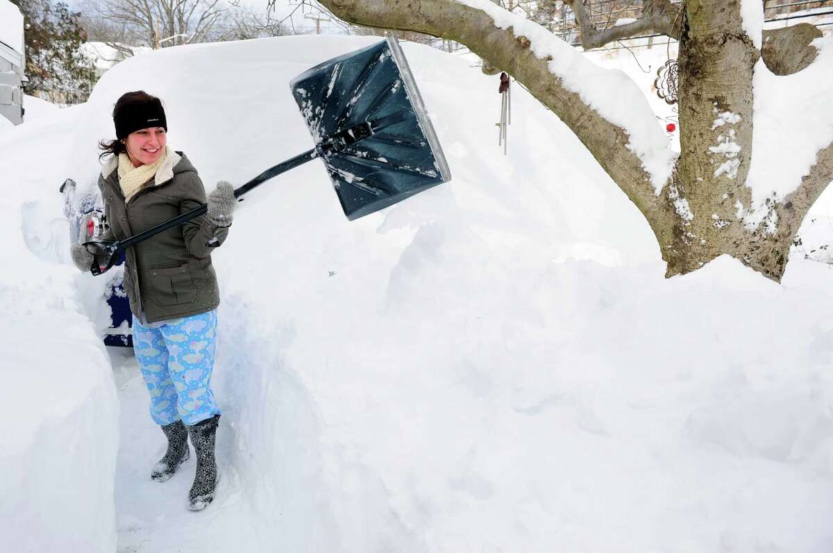 Chloe Campoli shovels a path from her house in Derby, Conn. as residents face massive snow removal Saturday, Feb. 9, 2013 following a severe blizzard that dumped up to three feet of snow across the state.