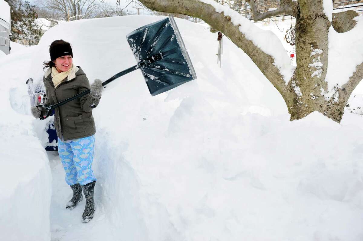 Chloe Campoli shovels a path from her house in Derby, Conn. as residents face massive snow removal Saturday, Feb. 9, 2013 following a severe blizzard that dumped up to three feet of snow across the state.