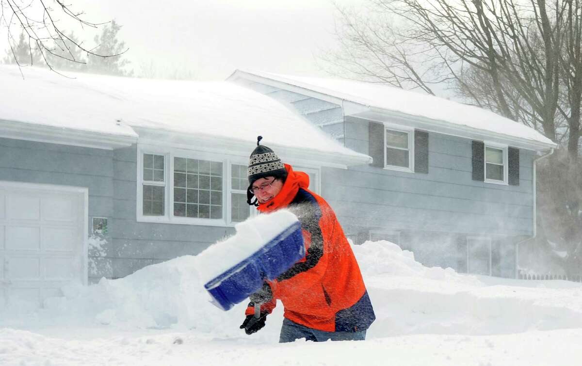 Jim Lucey fights the wind as he shovels out at his Katona Dr. home in Fairfield, Conn. on Saturday, Feb. 9, 2013. An overnight blizzard dumped over two feet of snow in Southwestern Connecticut.