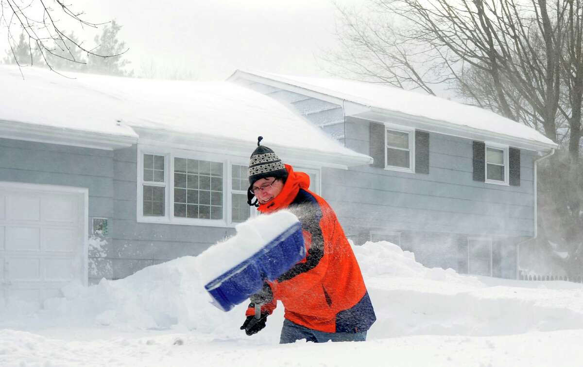Jim Lucey fights the wind as he shovels out at his Katona Dr. home in Fairfield, Conn. on Saturday, Feb. 9, 2013. An overnight blizzard dumped over two feet of snow in Southwestern Connecticut.