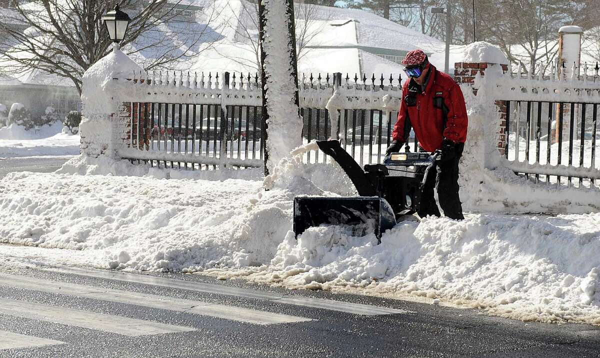A man uses a snowblower in Stamford, Conn., on Saturday, February 9, 2013.