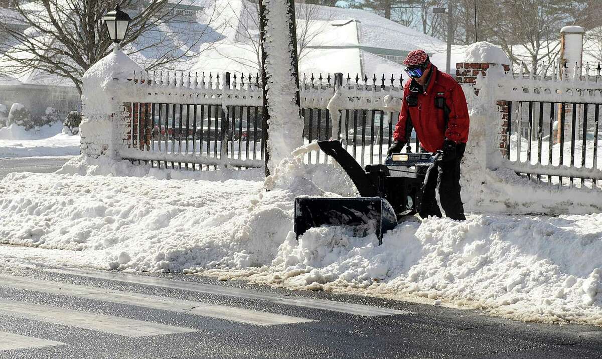 A man uses a snowblower in Stamford, Conn., on Saturday, February 9, 2013.