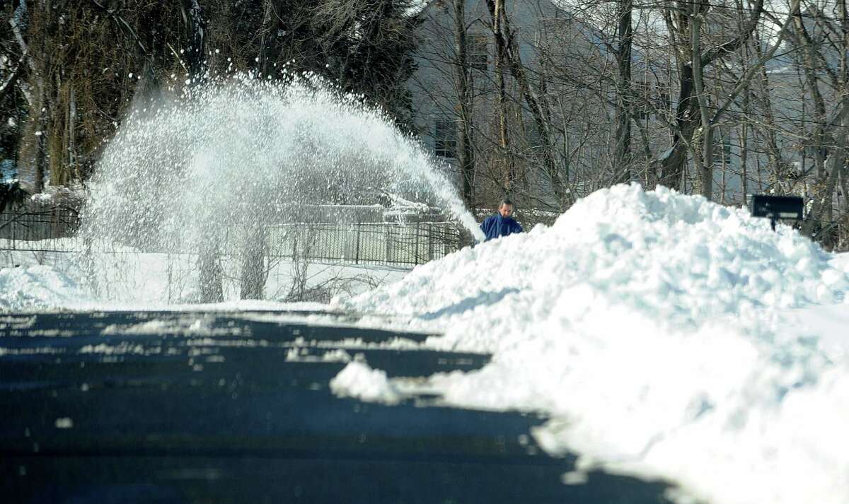 A man uses a snowblower in Stamford, Conn., on Saturday, February 9, 2013.