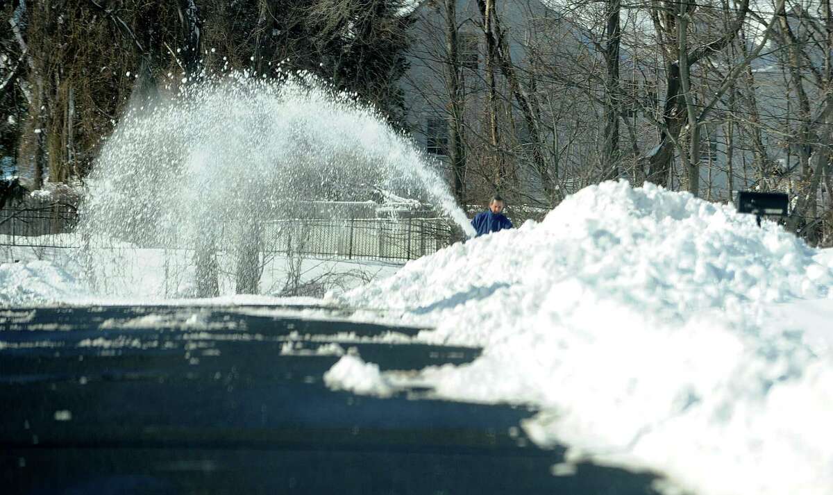 A man uses a snowblower in Stamford, Conn., on Saturday, February 9, 2013.