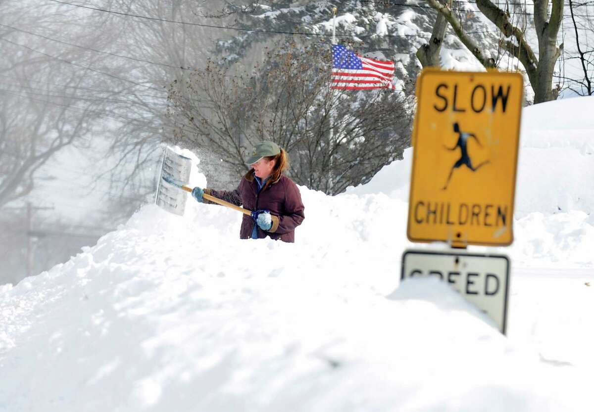 Sandra Pederzini shovels her driveway on Judd St. in Fairfield, Conn. on Saturday, Feb. 9, 2013. Southwestern Connecticut was hit by one of the biggest snowstorms in history, a howling blizzard that dumped up to three feet of snow across the state.