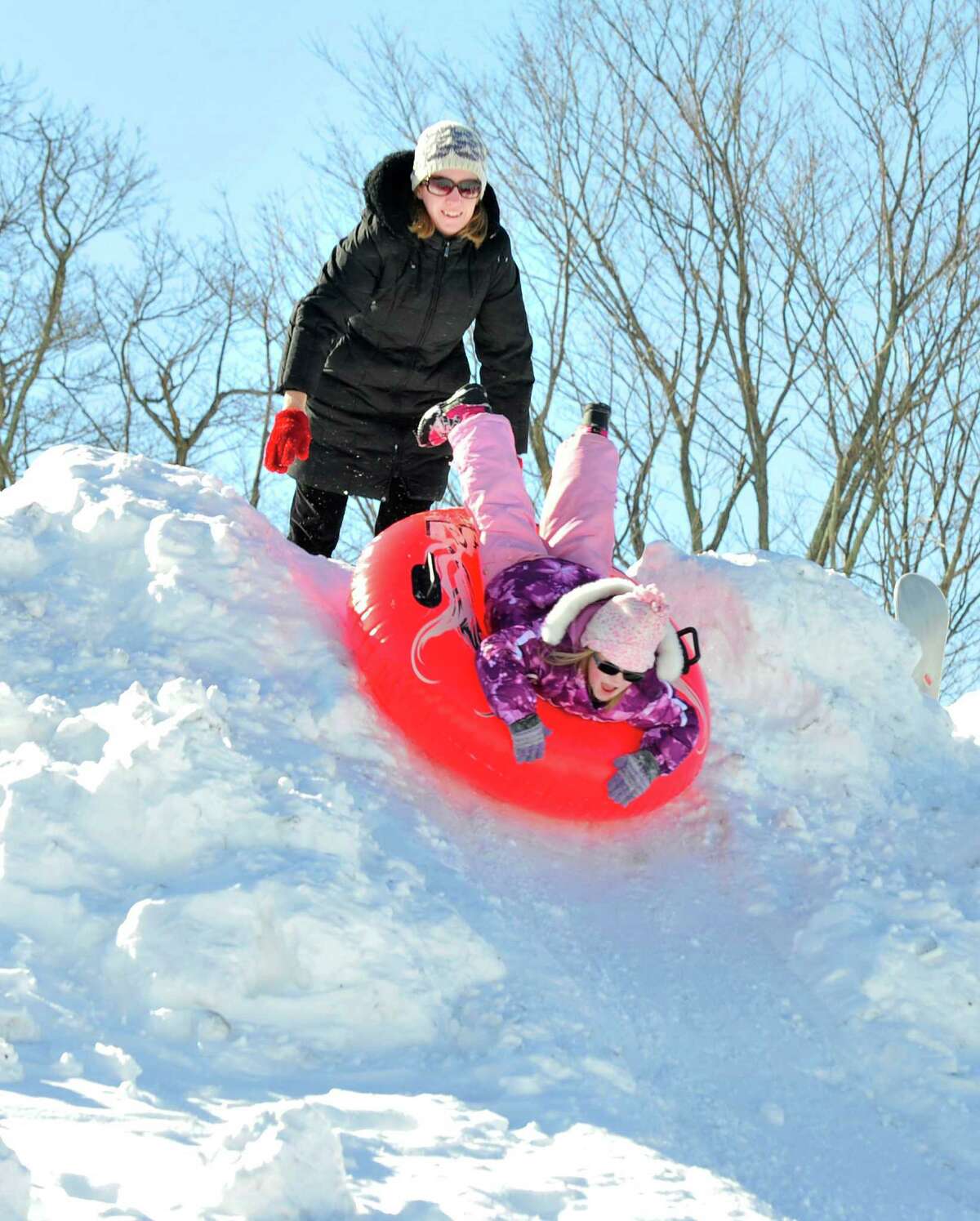 Residents have fun sledding in the snow behind St. Gregory the Great Church in Danbury Saturday, Feb. 9, 2013.
