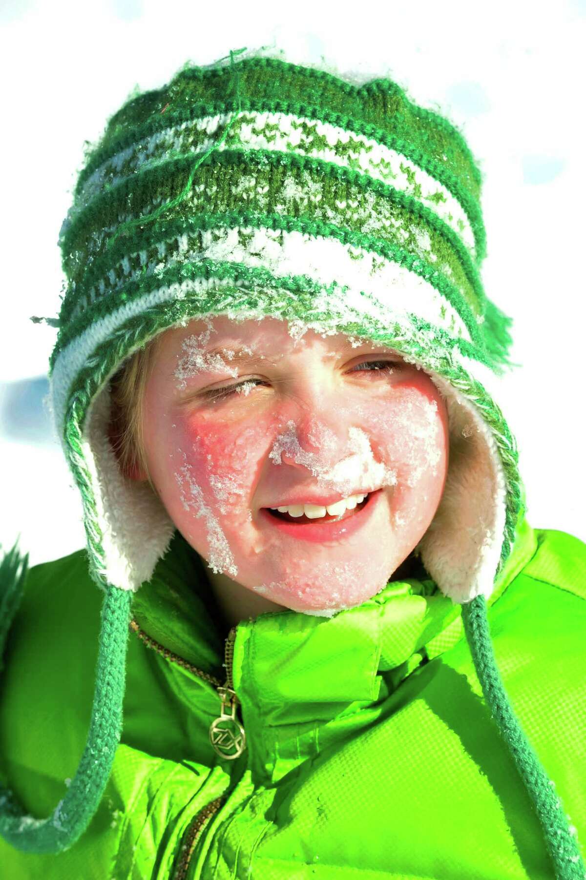 Caroline Williams, 10, gets a face full of snow while sledding behind St. Gregory the Great Church in Danbury Saturday, Feb. 9, 2013.