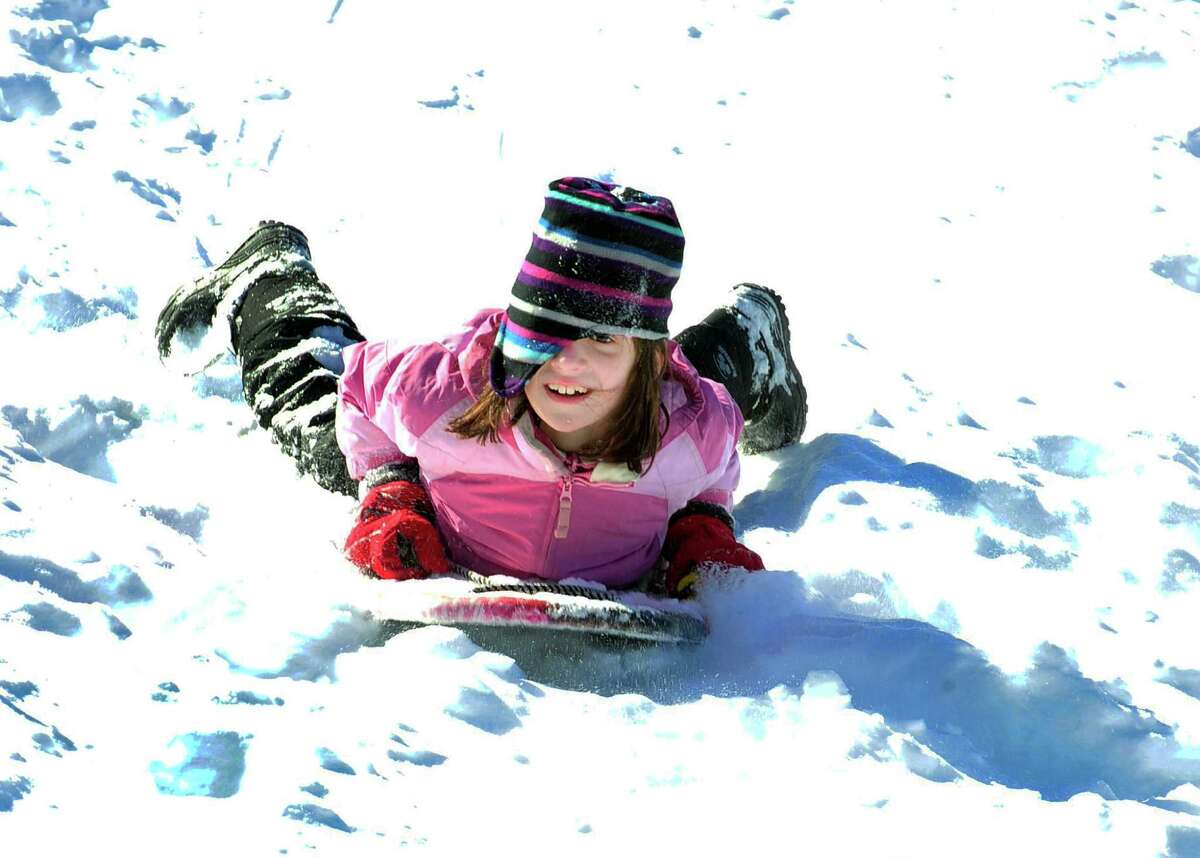 Margaret Swenson, 9, gets a wild ride behind St. Gregory the Great Church in Danbury Saturday, Feb. 9, 2013.