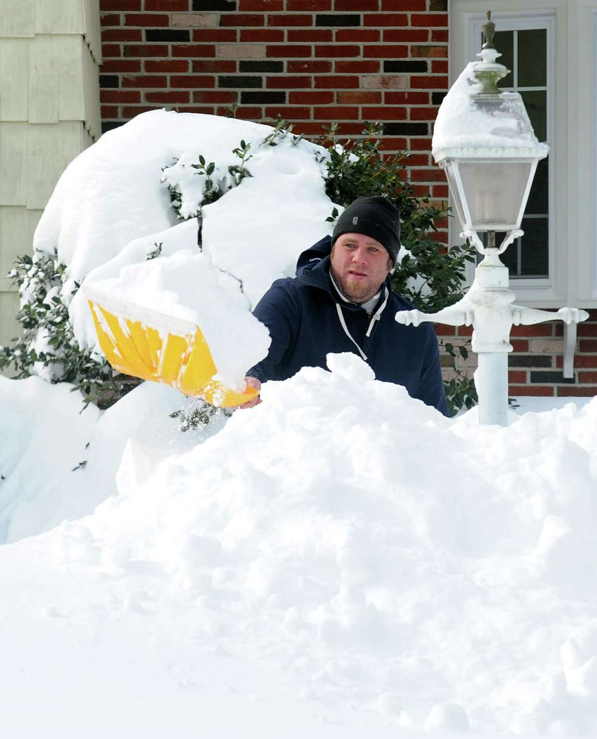 Billy Shaw digs out on High St.after an overnight blizzard dumped over two feet of snow in Fairfield, Conn. on Saturday, Feb. 9, 2013. Southwestern Connecticut was hit by one of the biggest snowstorms in history, a howling blizzard that dumped up to three feet of snow across the state.