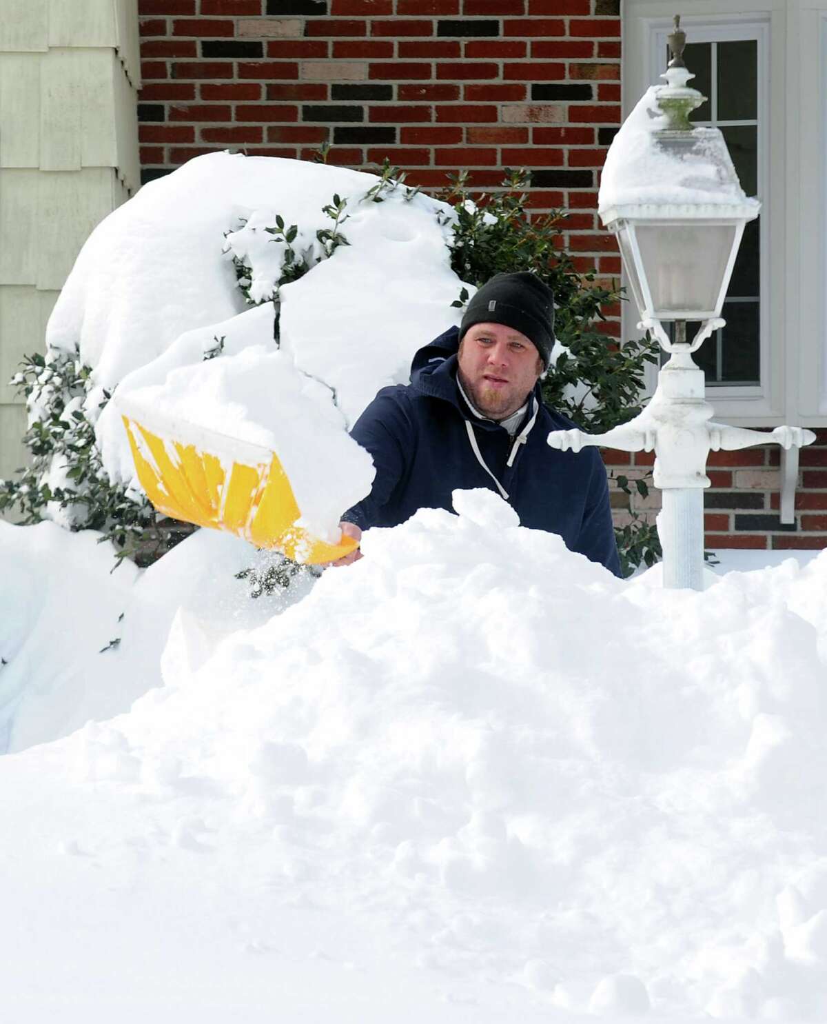Billy Shaw digs out on High St.after an overnight blizzard dumped over two feet of snow in Fairfield, Conn. on Saturday, Feb. 9, 2013. Southwestern Connecticut was hit by one of the biggest snowstorms in history, a howling blizzard that dumped up to three feet of snow across the state.