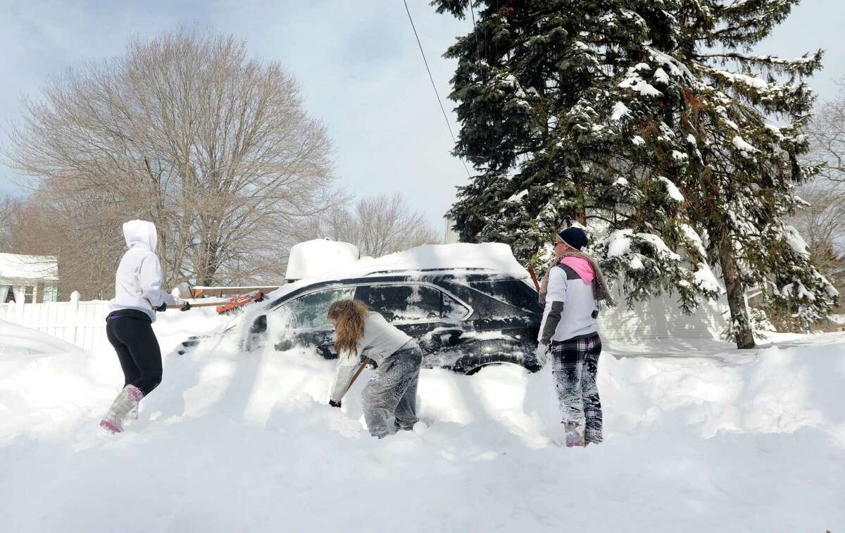 Janine Dubois, Tala Malas and Alley Meyer dig out Janine's car parked on Kalan Circle in Fairfield, Conn. on Saturday, Feb. 9, 2013. Southwestern Connecticut was hit by one of the biggest snowstorms in history, a howling blizzard that dumped up to three feet of snow across the state