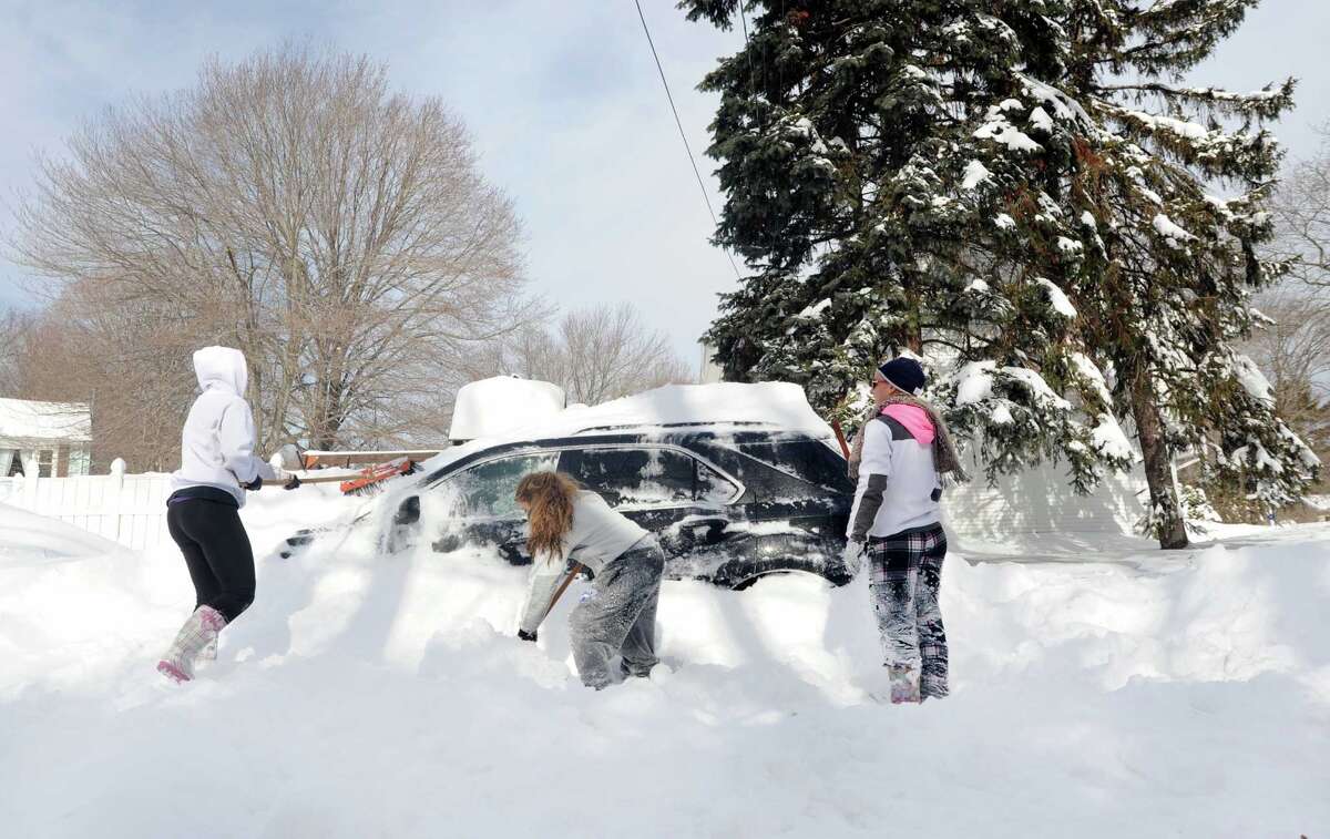 Janine Dubois, Tala Malas and Alley Meyer dig out Janine's car parked on Kalan Circle in Fairfield, Conn. on Saturday, Feb. 9, 2013. Southwestern Connecticut was hit by one of the biggest snowstorms in history, a howling blizzard that dumped up to three feet of snow across the state