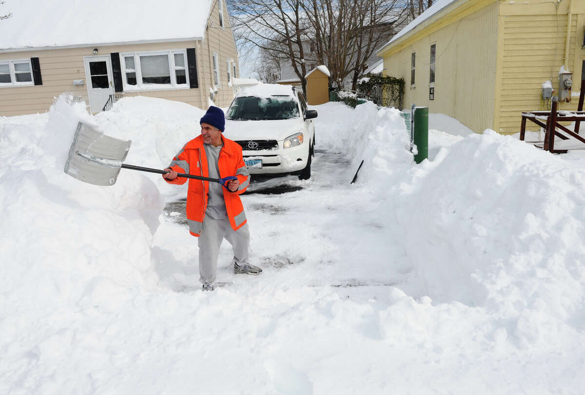 Resdident Ed Valente shovels his driveway after a blizzard pounded the region in West Haven, Conn. on Saturday February 9, 2013.
