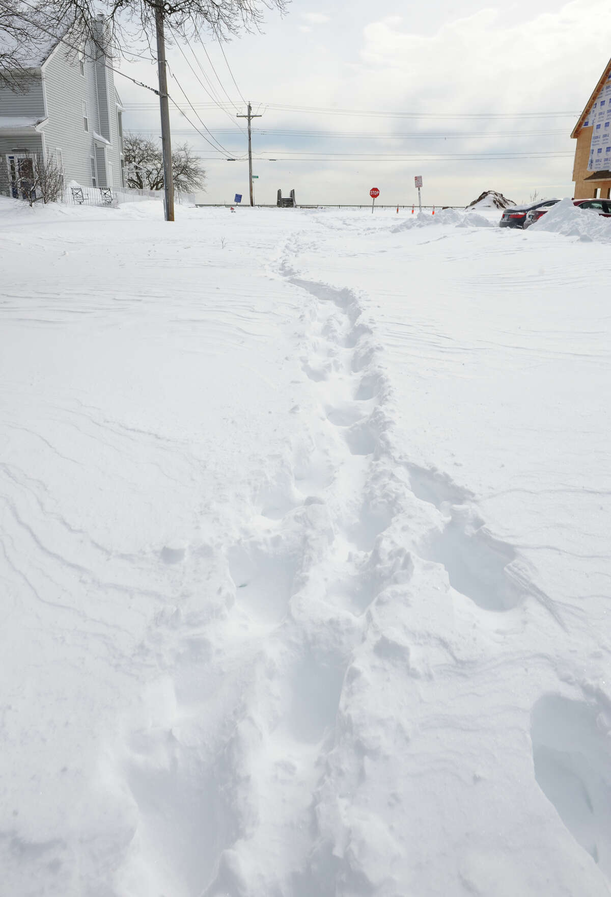 Footsteps are the only marks made on a side street after a blizzard pounded the region in West Haven, Conn. on Saturday February 9, 2013.