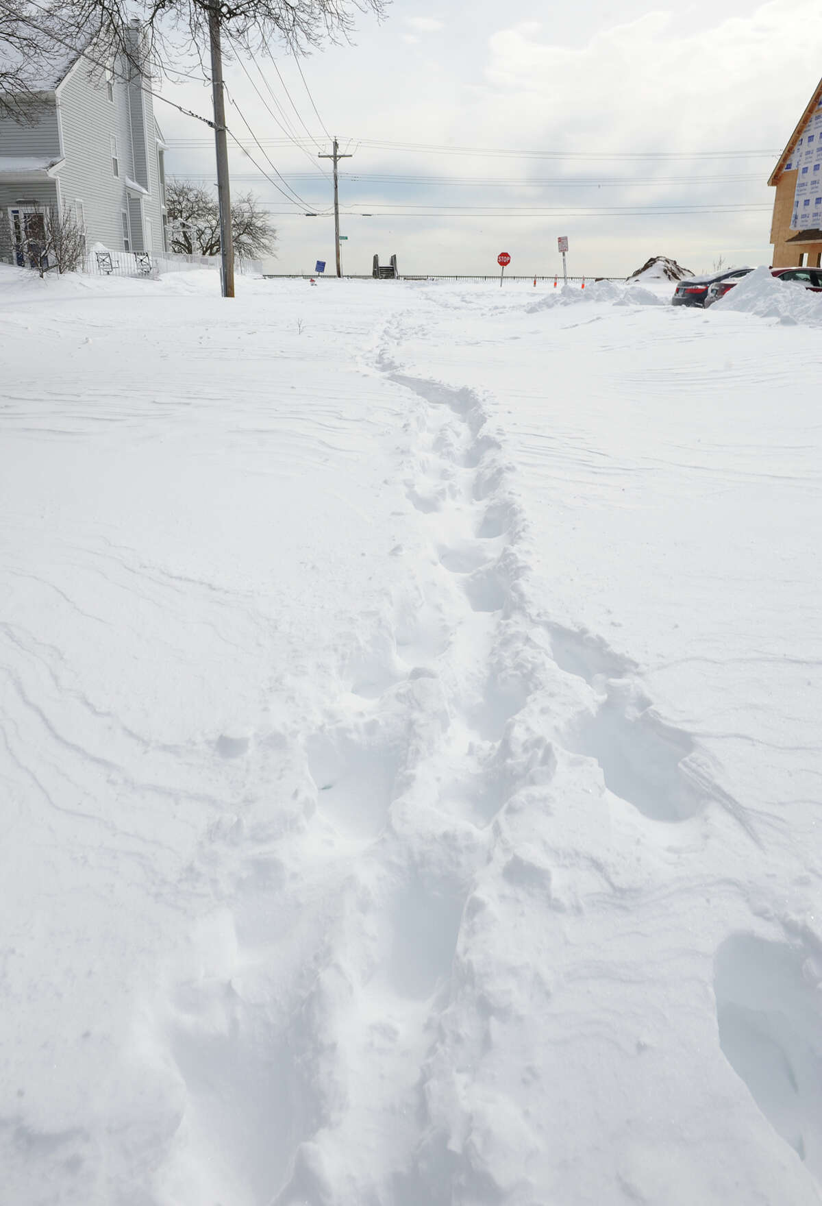 Footsteps are the only marks made on a side street after a blizzard pounded the region in West Haven, Conn. on Saturday February 9, 2013.