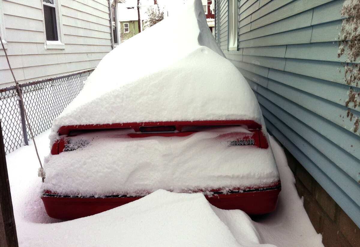 Snow almost buries a vehicle after a blizzard pounded the region in West Haven, Conn. on Saturday February 9, 2013.