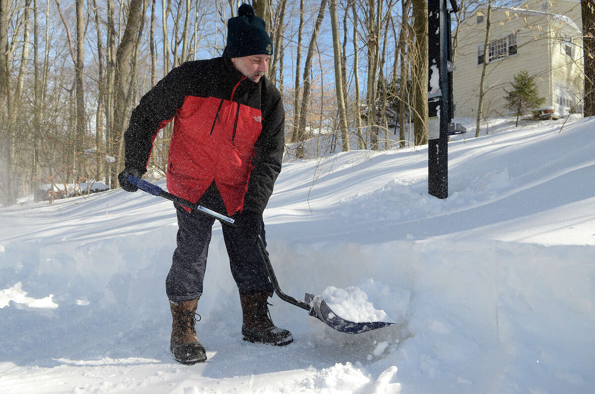 Ken Moore clears the snow from his driveway in Southport, CT on Sat., Feb. 9, 2013, following a blizzard that dumped up to three feet of snow across the state. However, his street hadn't yet been plowed, so he didn't expect to be going anywhere anytime soon in his car.