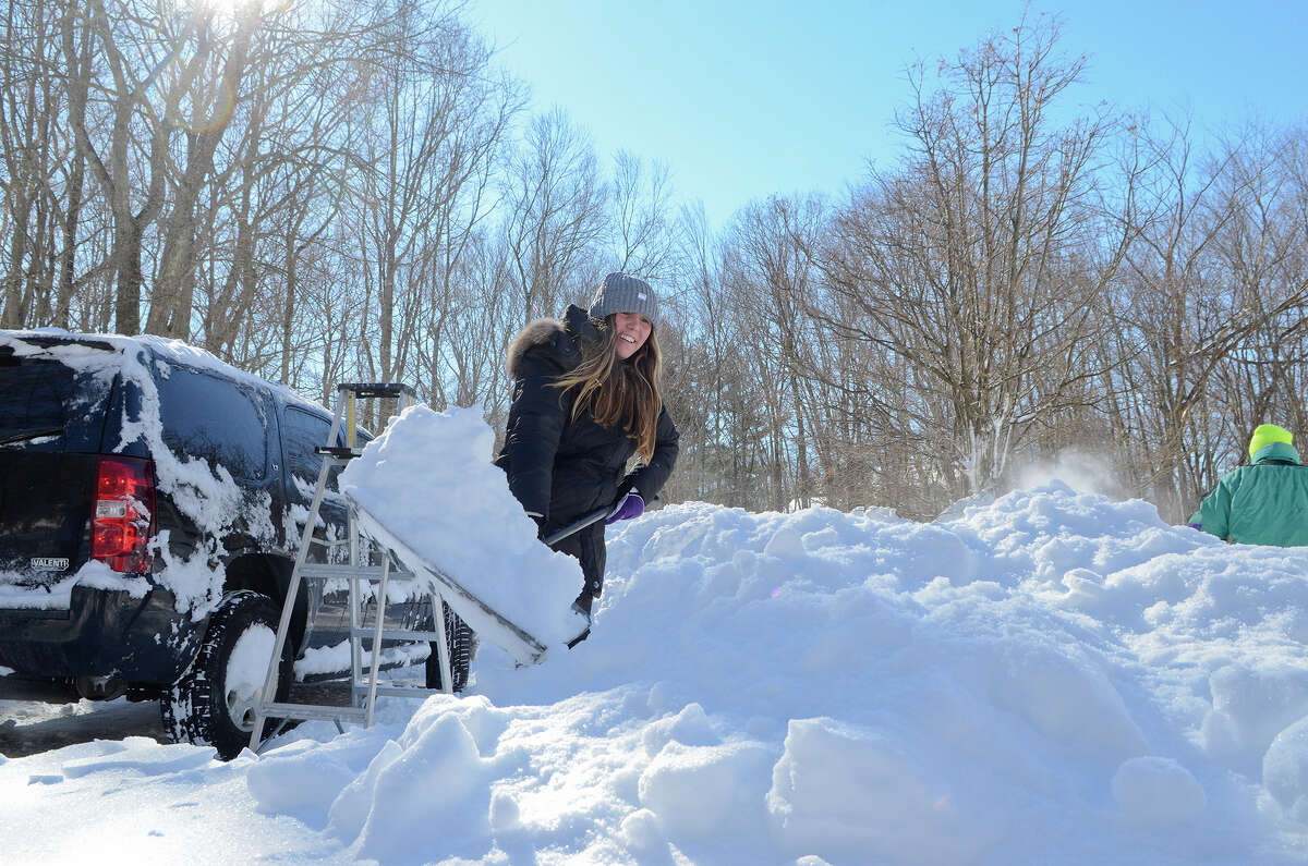 Ana Wyckoff, 16 next week, helps shovel her family's driveway in Southport, CT on Sat., Feb. 9, 2013, following a blizzard that dumped up to three feet of snow across the state. Earlier, Ana and her mom had used the ladder in the background to clear off the top of the family car.