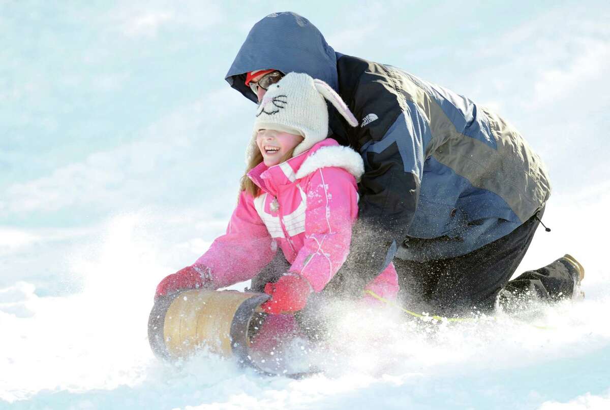 Tito Citarella attempts to steer his toboggan as his daughter, Claire, 6, holds onto the front of the sled as the pair took advantage of the snow sledding on the hill near the Western Greeenwich Civic Center during the aftermath of the blizzard that hit Greenwich, Saturday, Feb. 9, 2013.