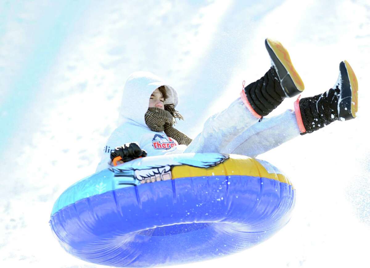 A girl on a sled jumps over a ramp on the hill near the Western Greeenwich Civic Center during the aftermath of the blizzard that hit Greenwich, Saturday, Feb. 9, 2013.