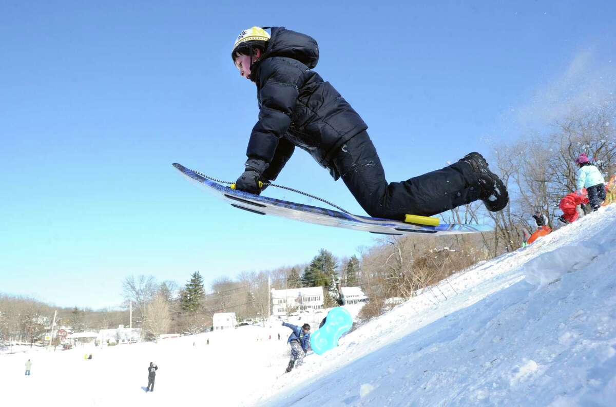 Josh Frumin, 10, of Greenwich, uses his sled to jump over a ramp on the hill near the Western Greeenwich Civic Center during the aftermath of the blizzard that hit Greenwich, Saturday, Feb. 9, 2013.