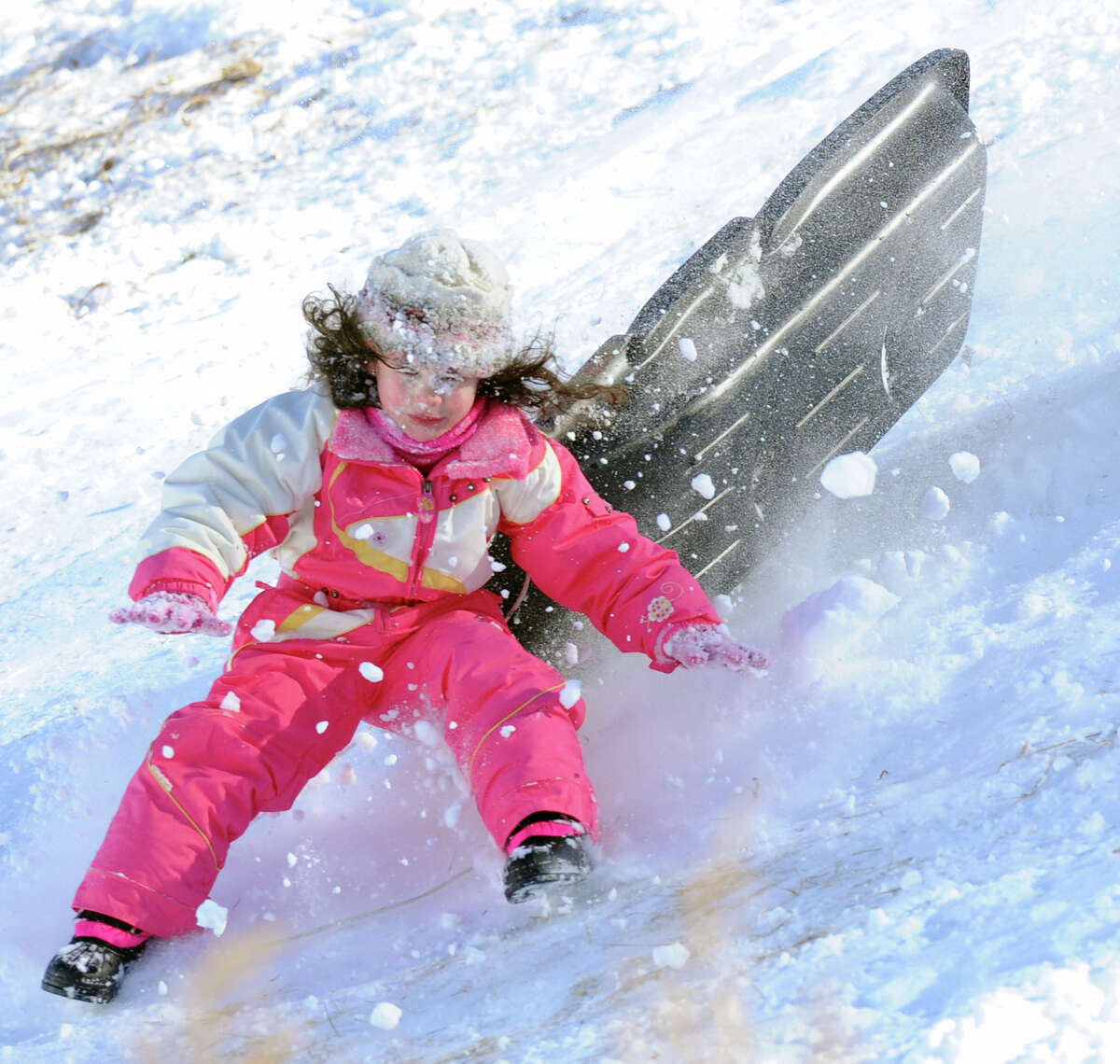 Emily Duarte, 5, of Glenville, wipes out as she jumps over a ramp on the hill near the Western Greeenwich Civic Center during the aftermath of the blizzard that hit Greenwich, Saturday, Feb. 9, 2013.