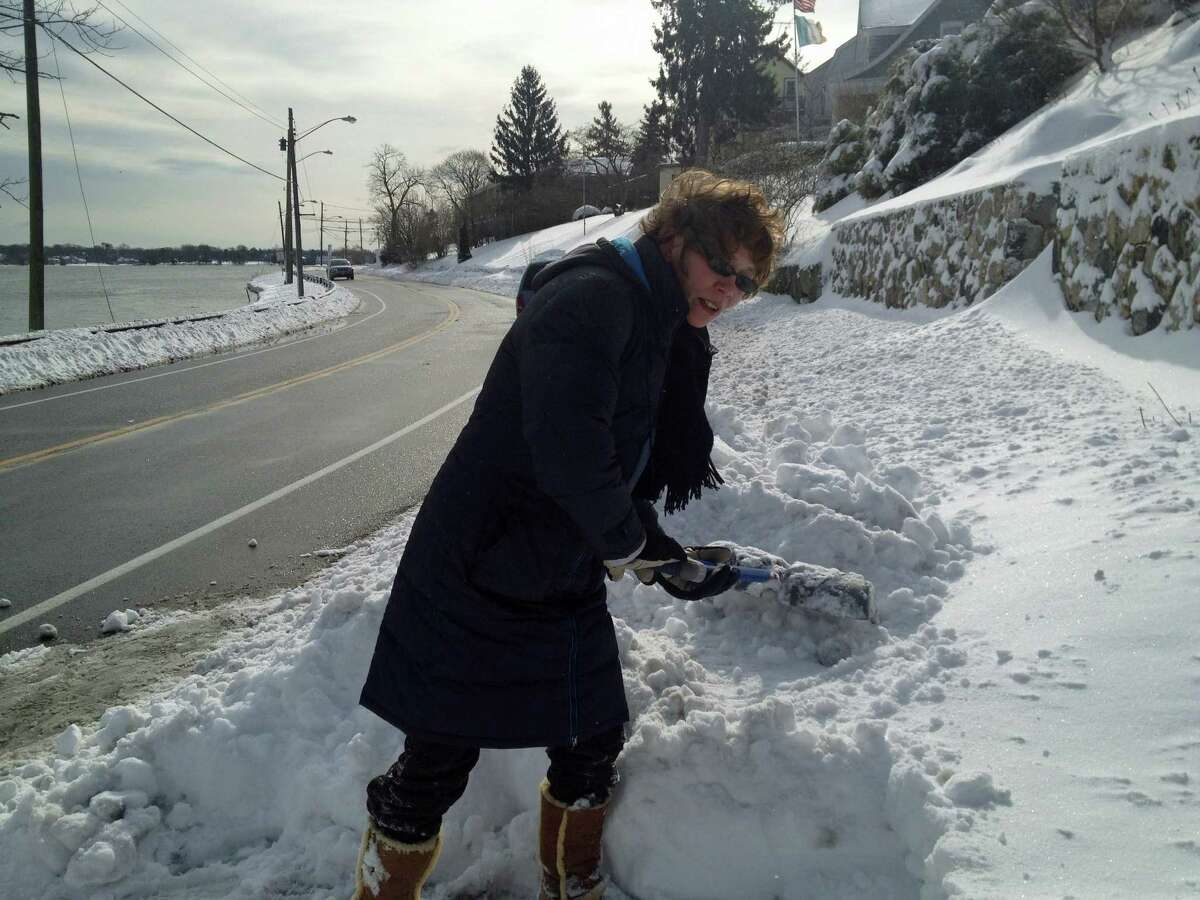 Elizabeth Luehrs of Weed Street on upper Holly Pond said shoveling the heavy snow was miserable, but she would rather do that than get flooded out again.