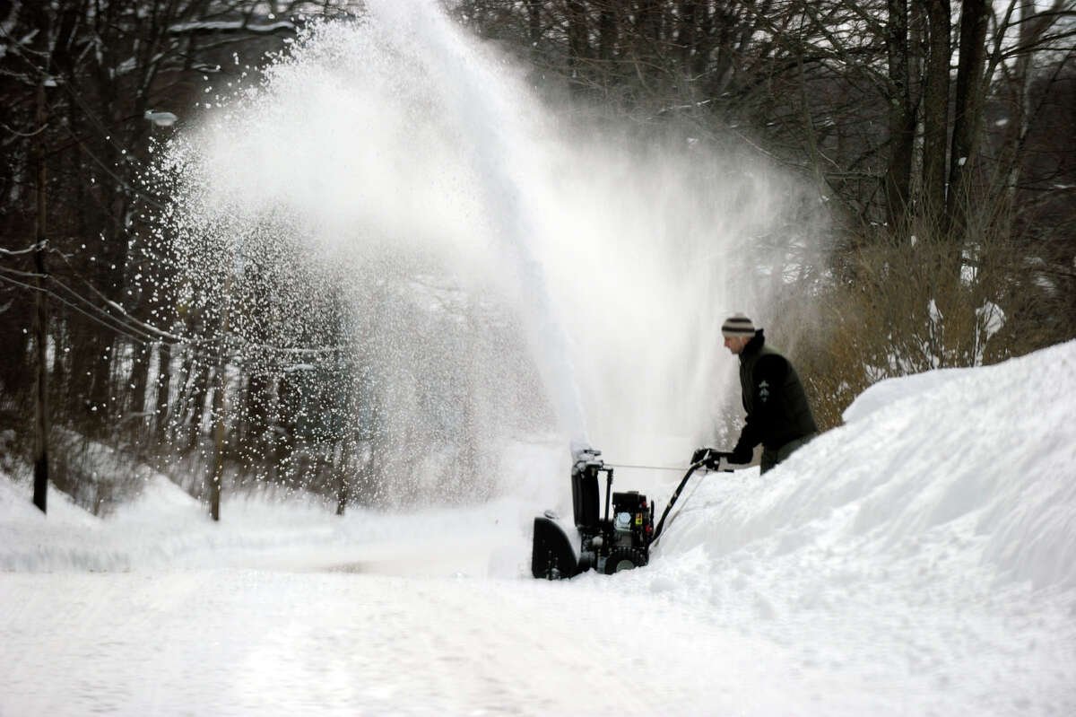 Max Veiga of Danbury uses a snowblower to clean his driveway on Coalpit Road in Danbury, Saturday, Feb. 9, 2013. A blizzard dumped about two feet of snow in the Danbury area Friday and early Saturday.