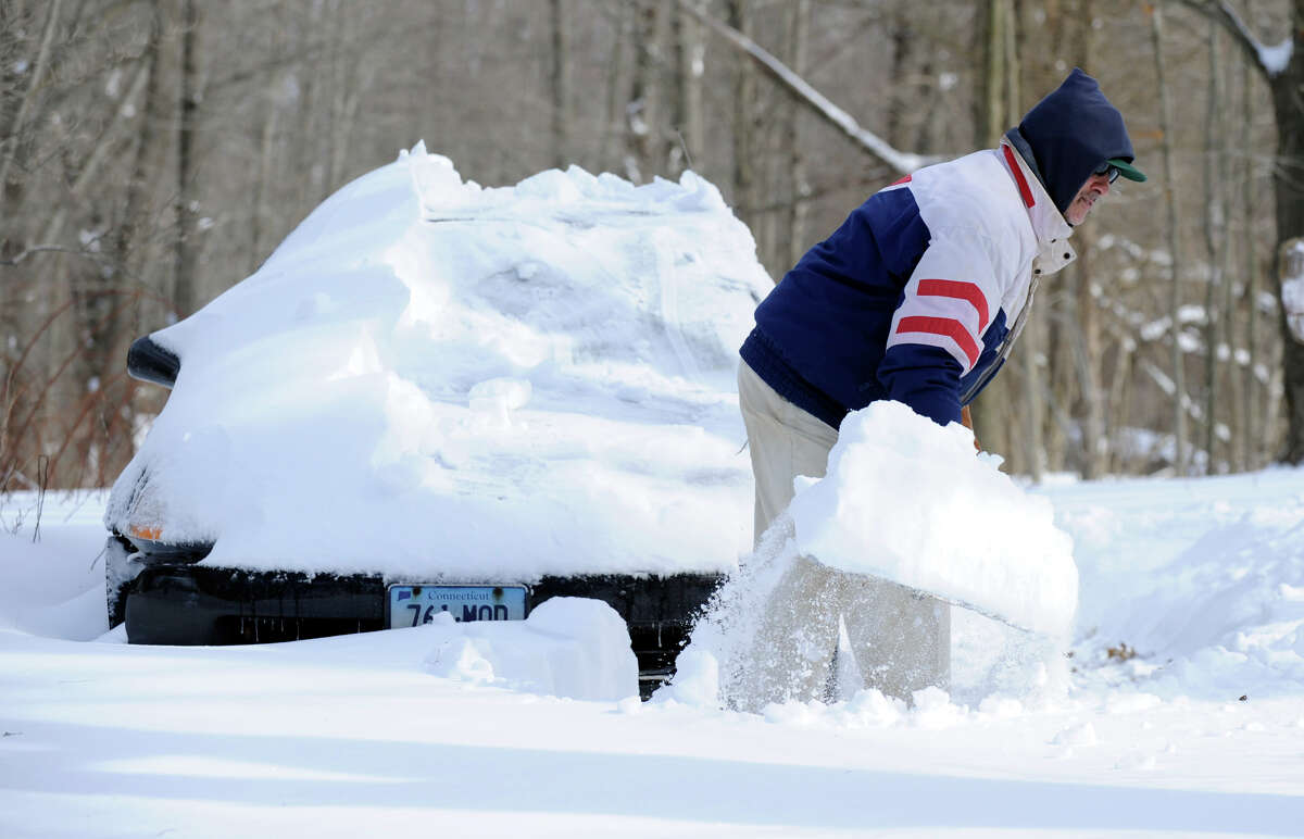 Dave Grosso digs out his car and driveway on Umpawaug Road in Redding Saturday, Feb. 9, 2012, after a blizzard dumped almost a two feet of snow on the area.