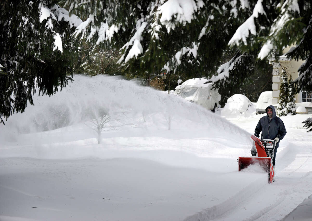 Tony Sousa, of Bethel, snowblows the driveway of his home on Route 53 in Bethel, Conn. Saturday afternoon, Feb. 9, 2013. A blizzard dumped almost a foot of snow on the Danbury area Friday and early Saturday morning.