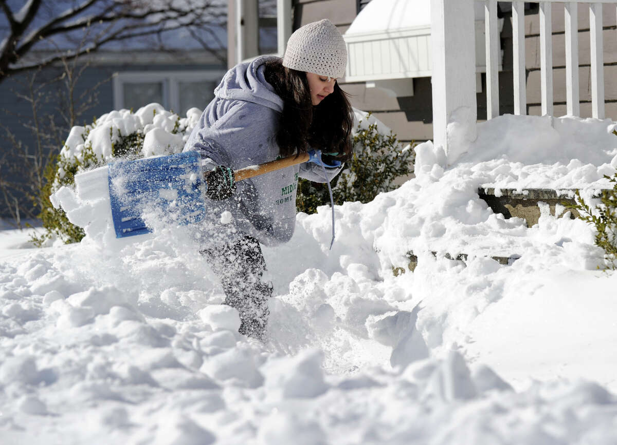 Teresa Forlenzo, 12, of Newtown, shovels the steps and walk of her family home on Glover Ave. in Newtown after a blizzard dumped almost two feet of snow Friday anto Saturday morning, Feb. 9, 2013.