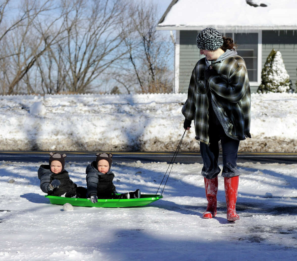 Genevieve Mulvaney pulls her twin sons on a sled around her home on Long Meadow Hill Road in Brookfield, Conn. Saturday, Feb. 9, 2012 after a blizzard dumped almost two feet of snow in the area.