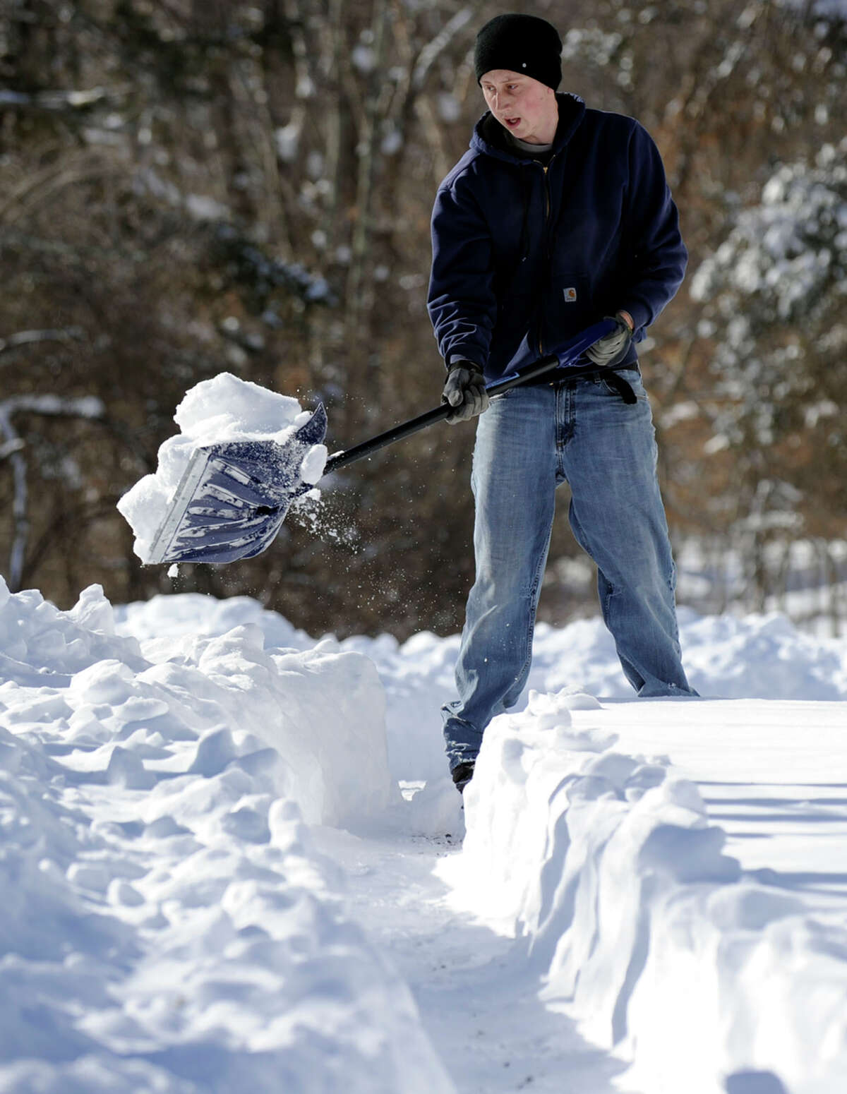 Jason Hanna, 24, shovels the driveway of his home on Hawleyville Road in Newtown, Conn. Saturday, February 9, 2013. A blizzard dumped almost two feet of snow in the area.