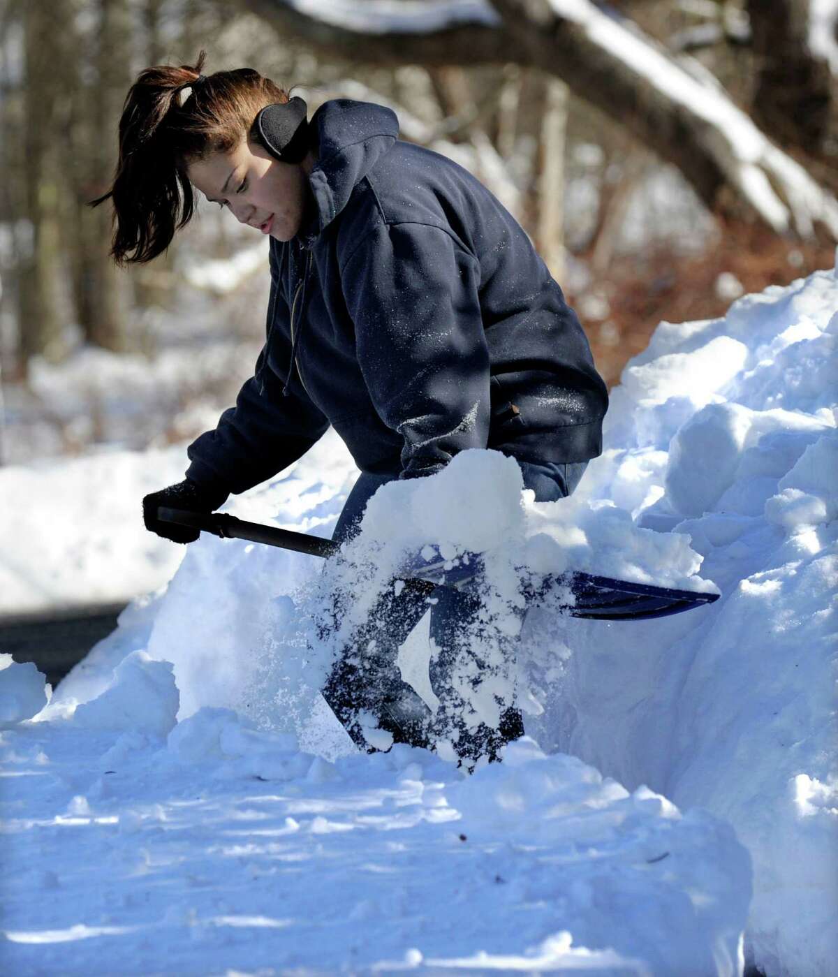 Andrea Hanna, 21, shovels the driveway of her home on Hawleyvilel Road in Newtown, Conn. Saturday, February 9, 2013. A blizzard dumped almost two feet of snow in the area.