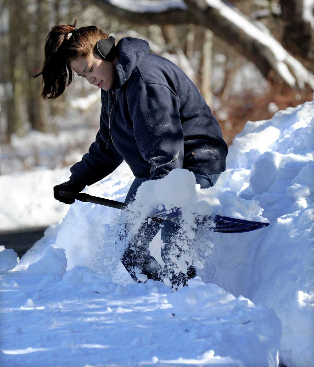 Andrea Hanna, 21, shovels the driveway of her home on Hawleyvilel Road in Newtown, Conn. Saturday, February 9, 2013. A blizzard dumped almost two feet of snow in the area.