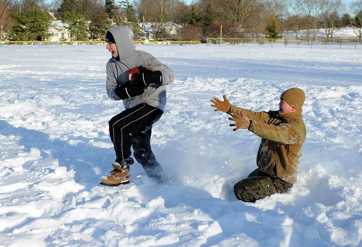 Mario Sciarretta, left, and Bobby Truong, right, play football in Cummings Park in Stamford, Conn., on Saturday, February 9, 2013.
