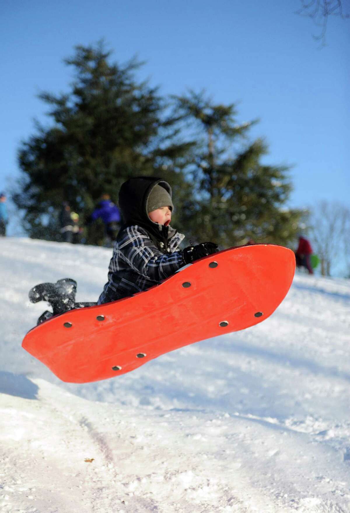 Liam Baird, 9, catches air on a hill in Cummings Park in Stamford, Conn., on Saturday, February 9, 2013.