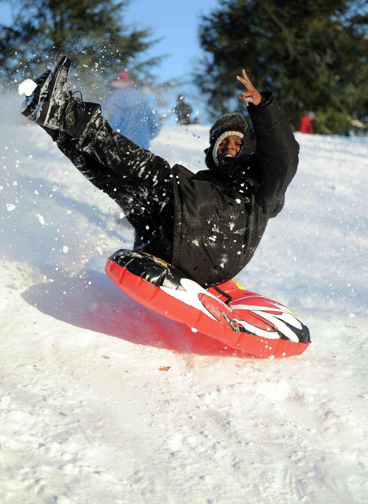 A sledder catches air on a hill in Cummings Park in Stamford, Conn., on Saturday, February 9, 2013.