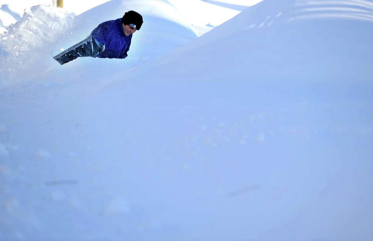 Haci Demir tries to find his car buried beneath the snow in Derby, Conn. Saturday, Feb. 9, 2013 following a severe blizzard that dumped up to three feet of snow across the state.