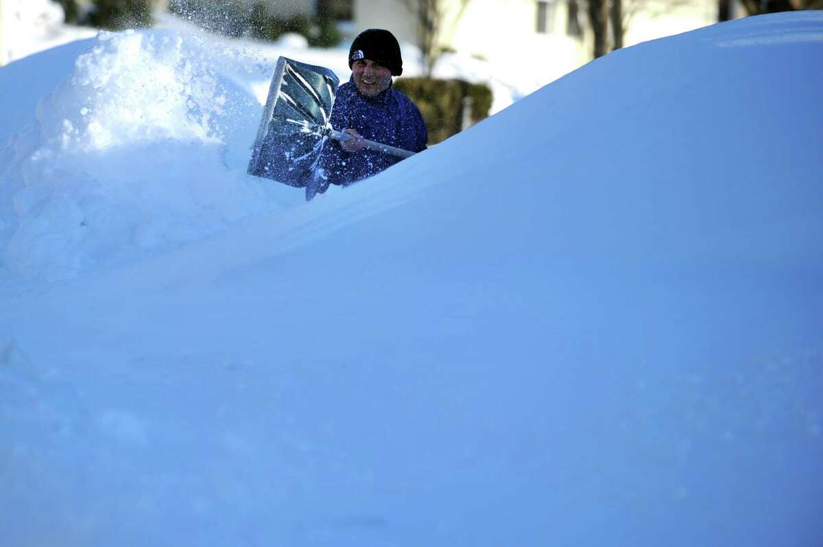 Haci Demir tries to find his car buried beneath the snow in Derby, Conn. Saturday, Feb. 9, 2013 following a severe blizzard that dumped up to three feet of snow across the state.
