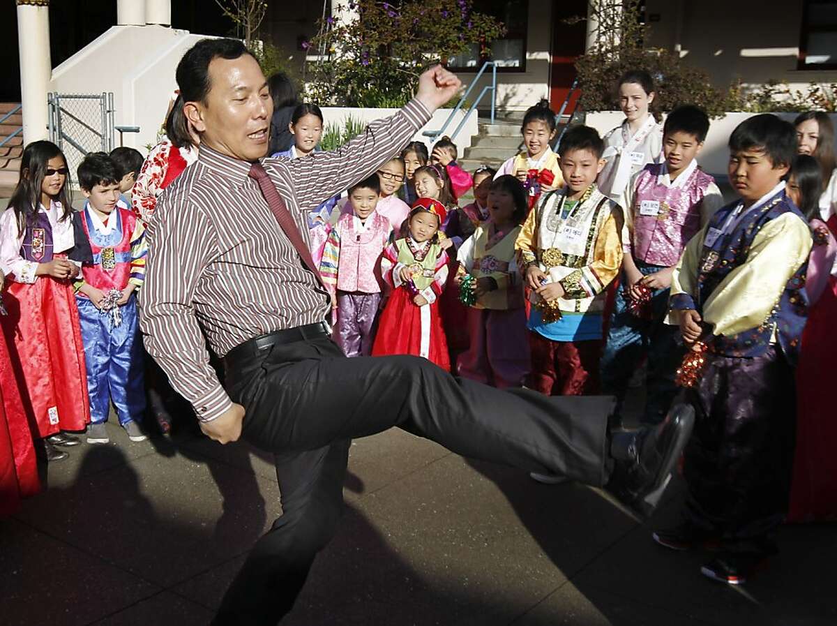 Joosik Shin, with the Korean Education Center for the Republic of Korea's consulate, demonstrates how to kick a jegichagi, which is similar to a hackysack. Students celebrateed Seol Nal, the Korean Lunar New Year, at the Claire Lilienthal School in San Francisco, Calif. on Friday, Feb. 8, 2013. Students in the Korean-immersion program wore traditional hanbok outfits and participated in a variety of activities to celebrate the lunar new year, which begins Sunday.