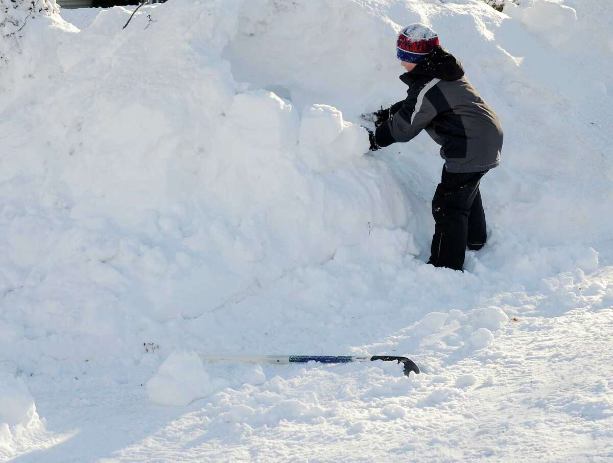 Dylan Hutzelmann makes an igloo in his driveway in Fairfield, Conn. on Friday, Feb. 9, 2013. Southwestern Connecticut was hit by one of the biggest snowstorms in history, a howl